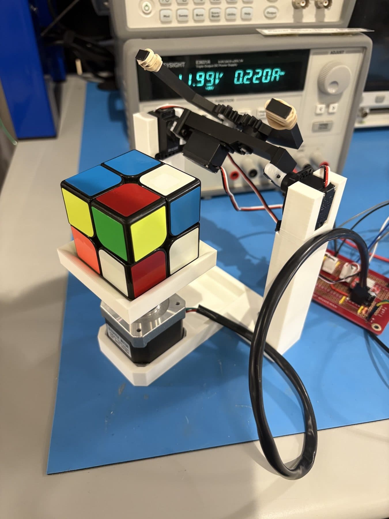 The cube solver holding a scrambled 2×2 cube