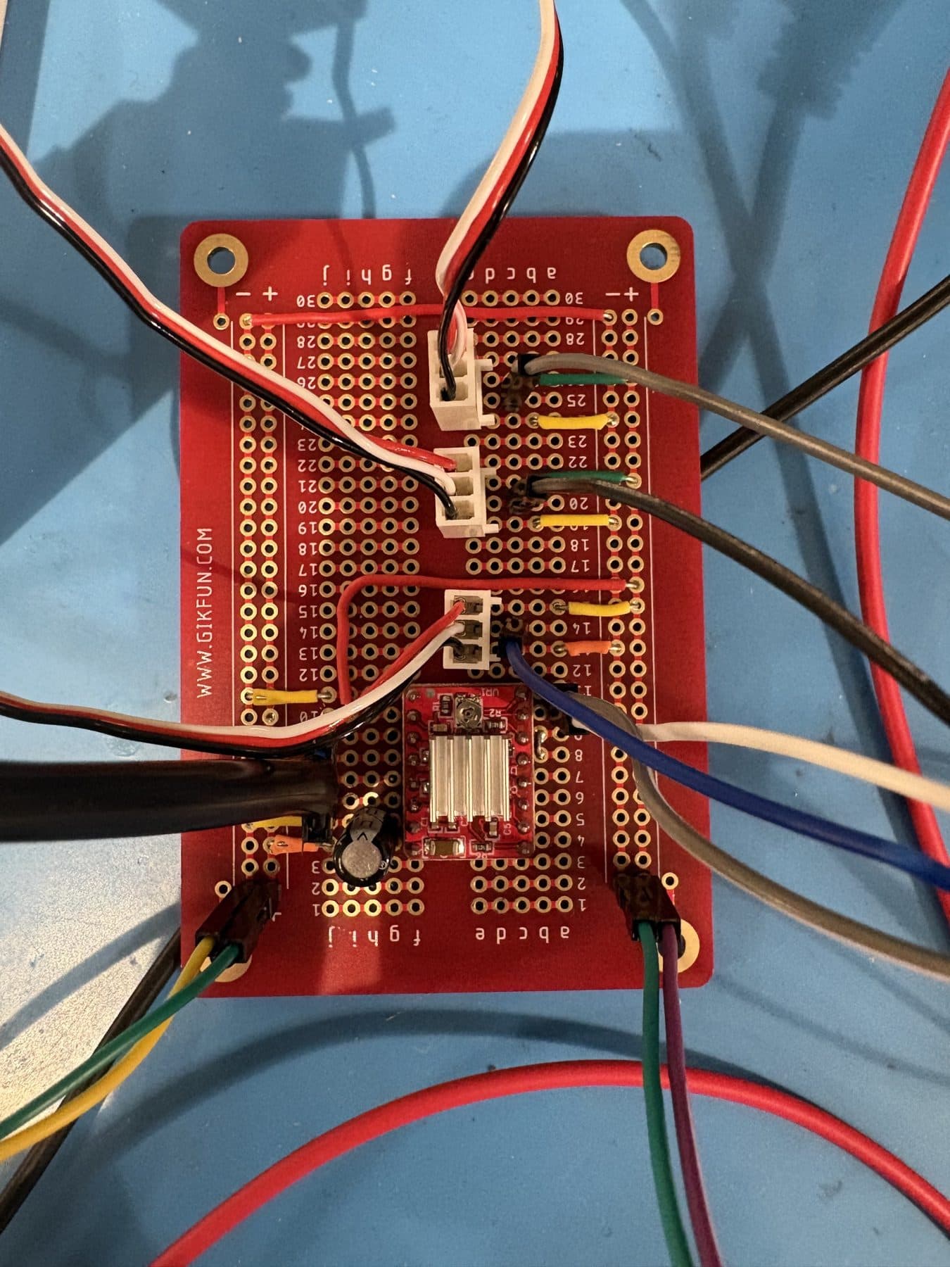Hand-wired perfboard with the stepper driver and servo headers